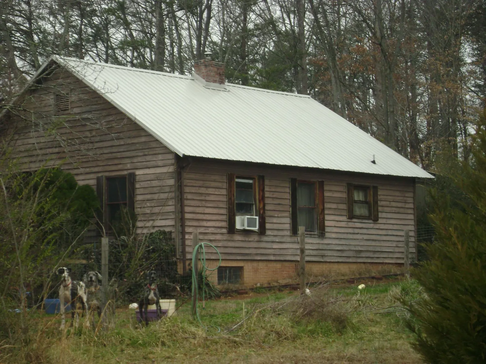 White metal roof on an old wood sided farmhouse, from a Metal Roof Installation job in Newton Upper Falls